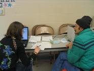 Christie Seaver assists a taxpayer with his return at the MLK site.
