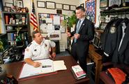 Peter Maher '13, right, talks with Rome deputy police chief Kevin Simons '88.