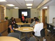 QSR Center director Mary O'Neill talks to students at the new offices.