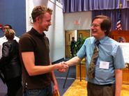 Sam Hincks '11 (left) is congratulated by Karl Wurst, conference co-chair.