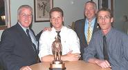 Mike Stahl '06, second from left, with Clinton Fire Department officers. (Photo by Gary Meyer)