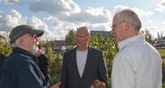 Rich Vellante '86, center, checks out Heritage Garden potatoes with Dave Gapp, left, and Frank Sciacca.