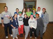 The women's basketball team and coach Sean Mackin take a break from painting at the Underground Cafe