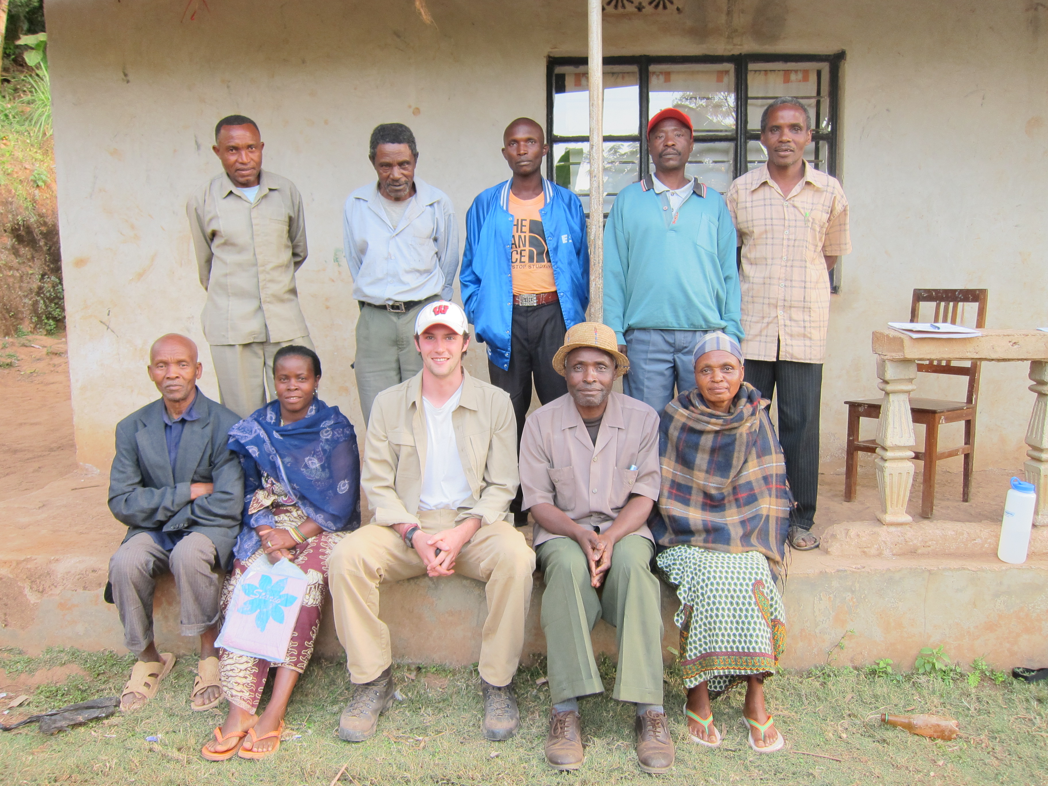 Eren Shultz '15 in the Pare Mountains, posing with the board members of the Gonja Sub-Kume Water Cooperative.