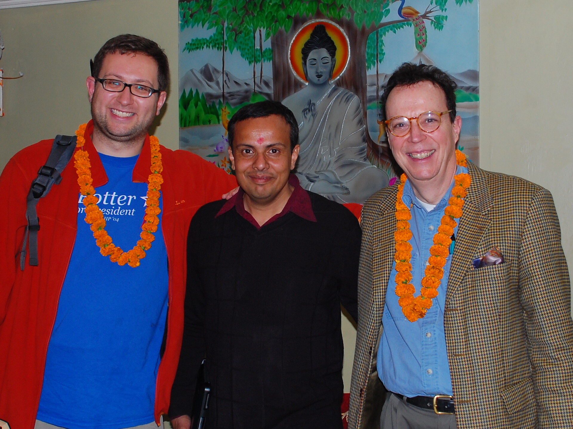From left, ITS Educational Technologist Ted Fondak, Assistant Professor of Religious Studies Abhishek Amar and Professor of French John O'Neal in front of a painting of the Buddha in India.