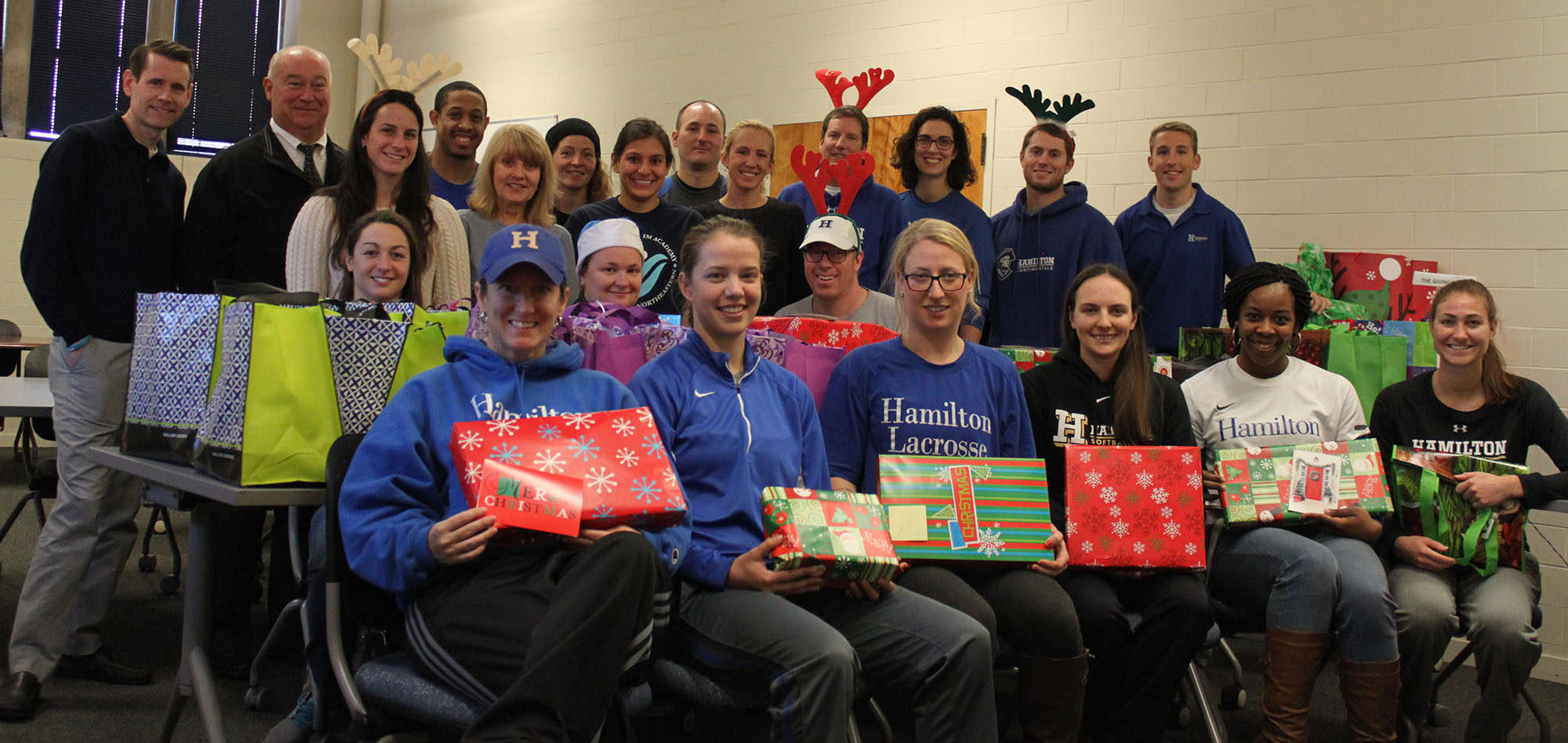 Athletics Department staff and coaches gathered to wrap gifts for the families they adopted through COOP's Holiday Gift Drive.