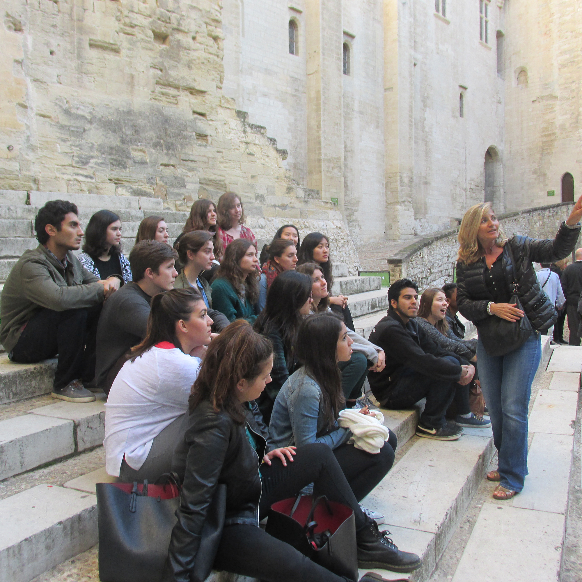 The Hamilton in France program group listens to a guide at the Palais.