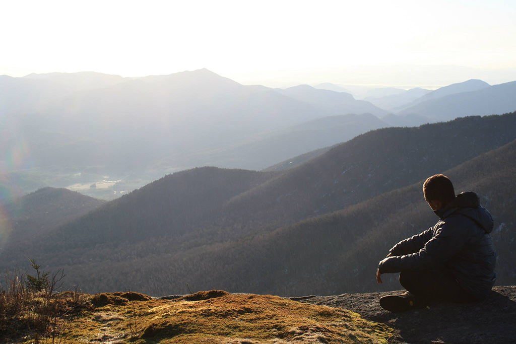 Purujith Gautam '16 takes in the sunrise from Cascade Mountain in the Adirondacks.