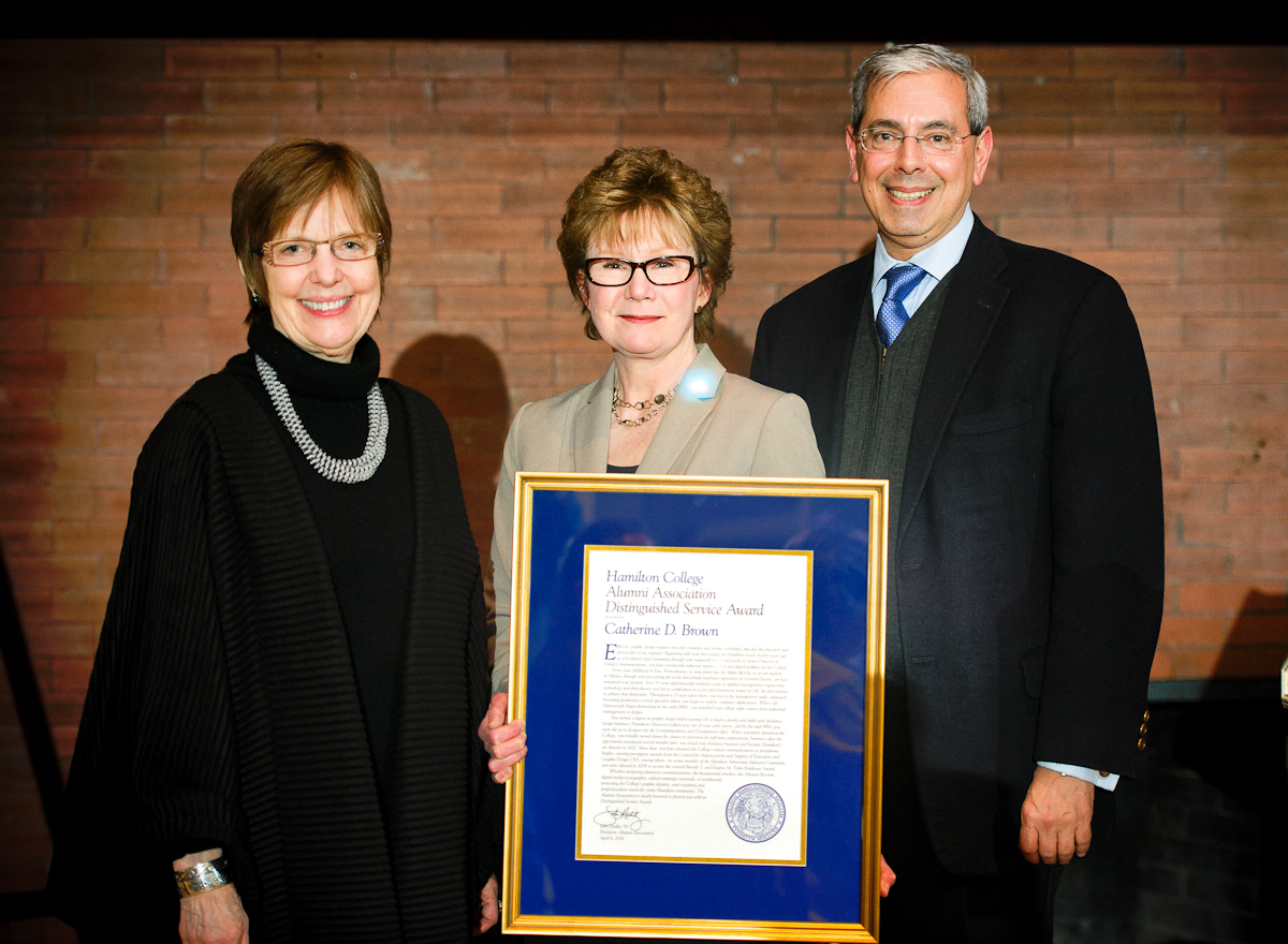Distinguished Service Award recipient Cathy Brown, center, with Hamilton President Joan Hinde Stewart and Alumni Association President John Hadity '83.