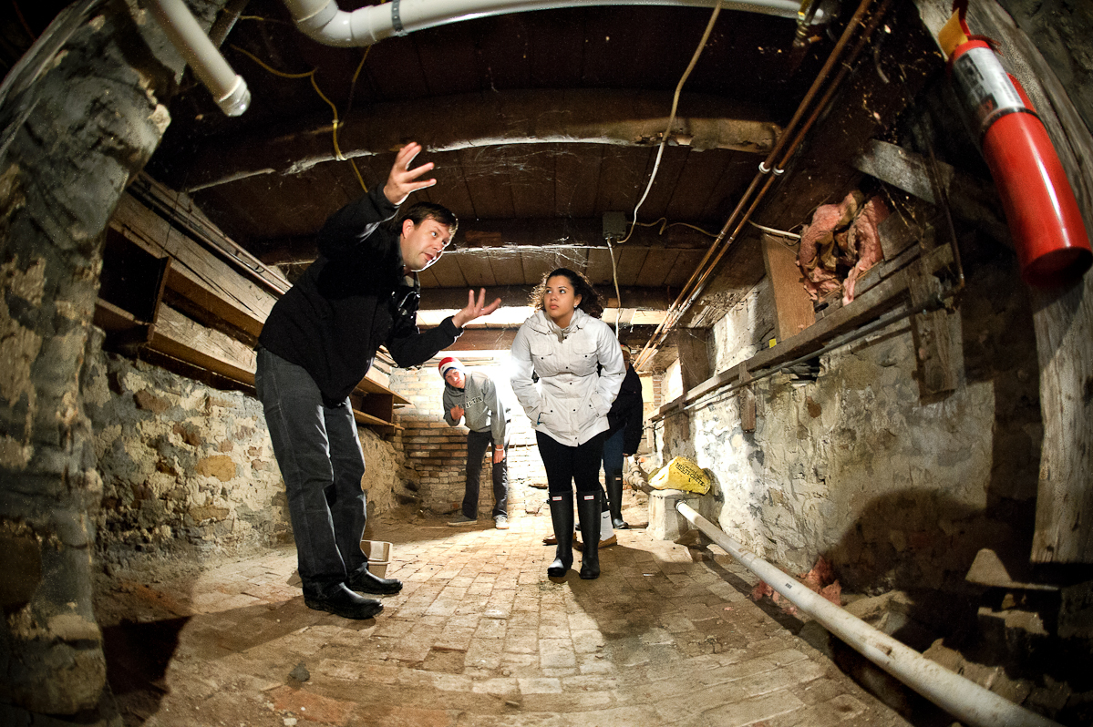 Assistant Professor of Anthropology Nathan Goodale gives Heidi Mendez '18 and other students in his archaeology class a tour of the root cellar at the house.