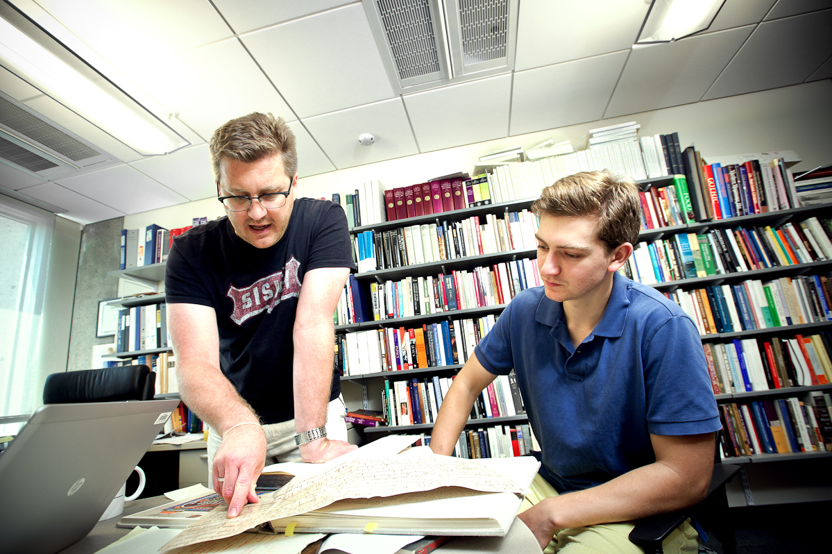 Matt Currier '16, right, reviews documents with Assistant Professor of History John Eldevik.