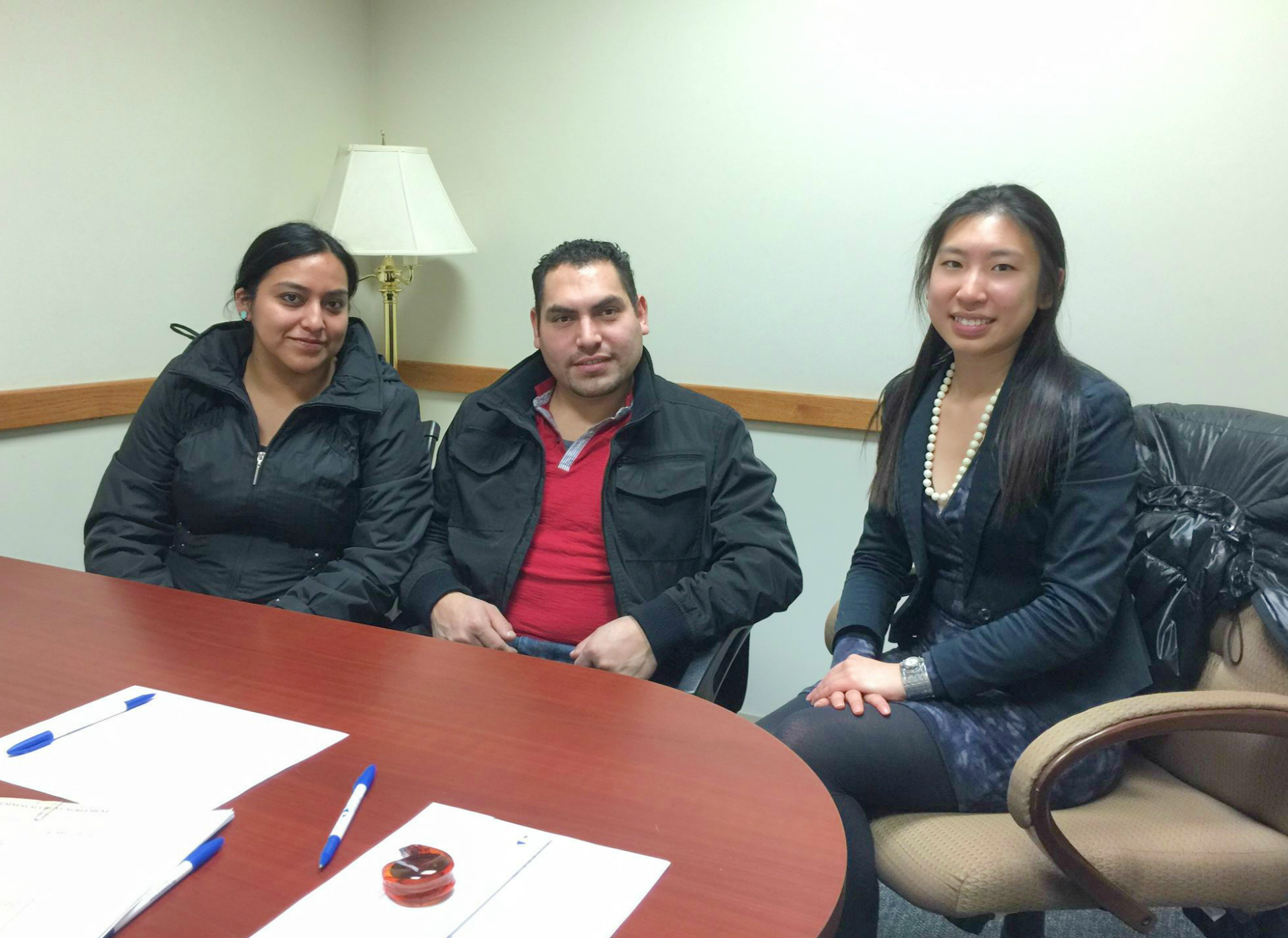 Lisa Yang '17, right, with Hamilton Microfinance loan recipient Lourdes Alvarez and her husband.