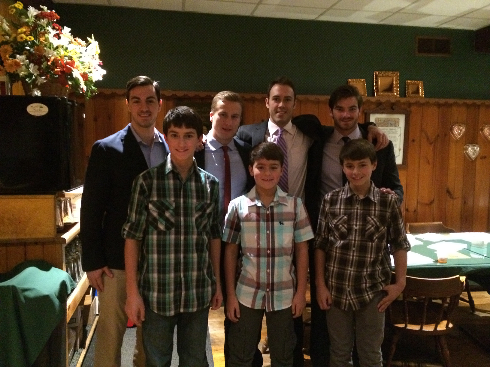 Back row: Men's hockey team members Conor Lamberti '17, Pat Sen '15, Tyler Lovejoy '16 and Charlie Fennell '17 with Connor, Caden, and Carter Hinderling. The Hamilton players alternate mornings babysitting for them before school.