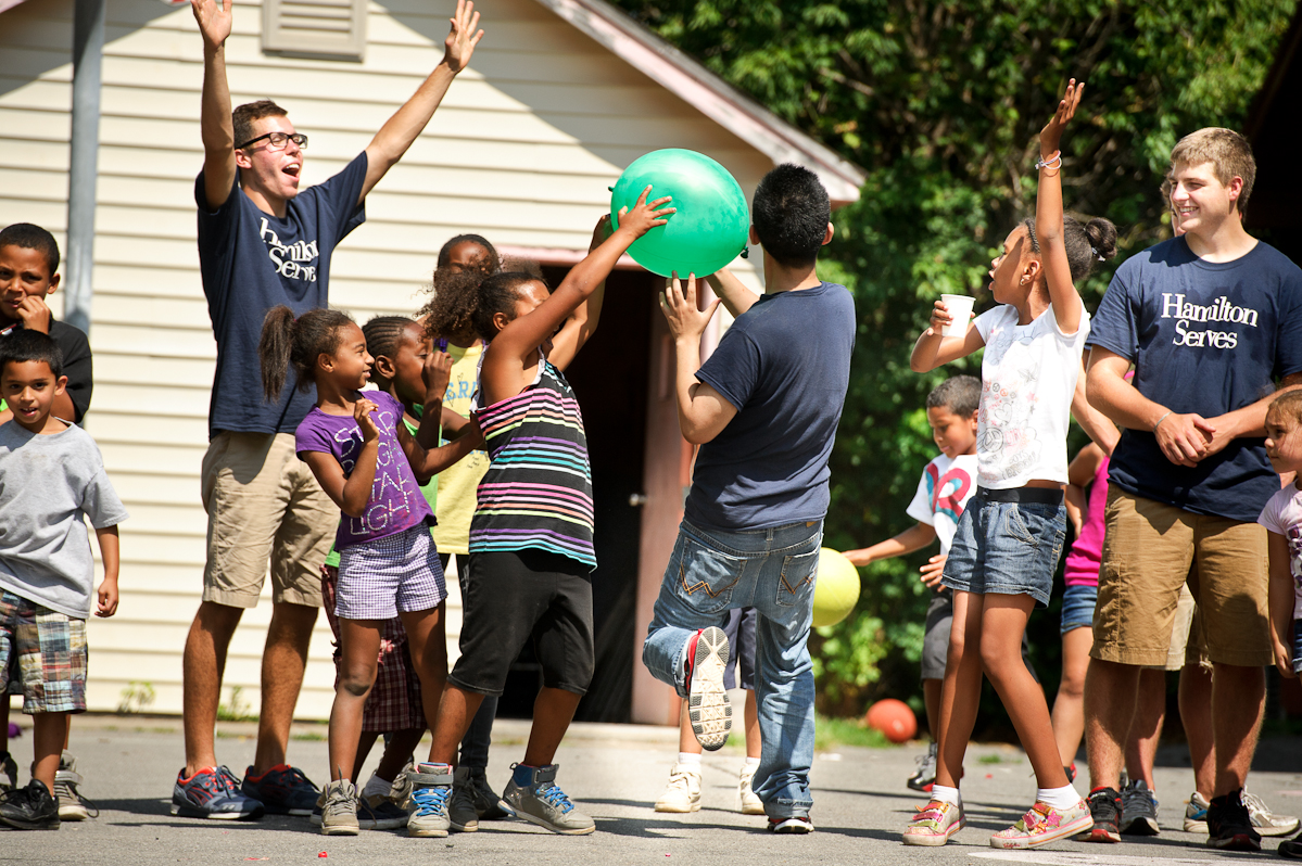 Members of the Class of 2017 play games with children at the Neighborhood Center in Utica as part of Hamilton Serves.