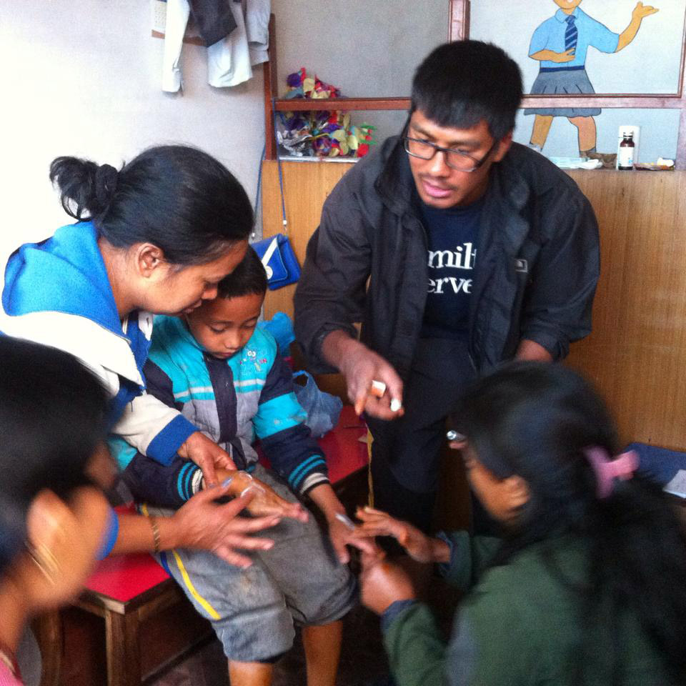 In Nepal, Ujjwal Pradhan's ’15 brother, Dr. Umesh Pradhan, right, provides medical care to victims from the neighborhoods of Balaju.