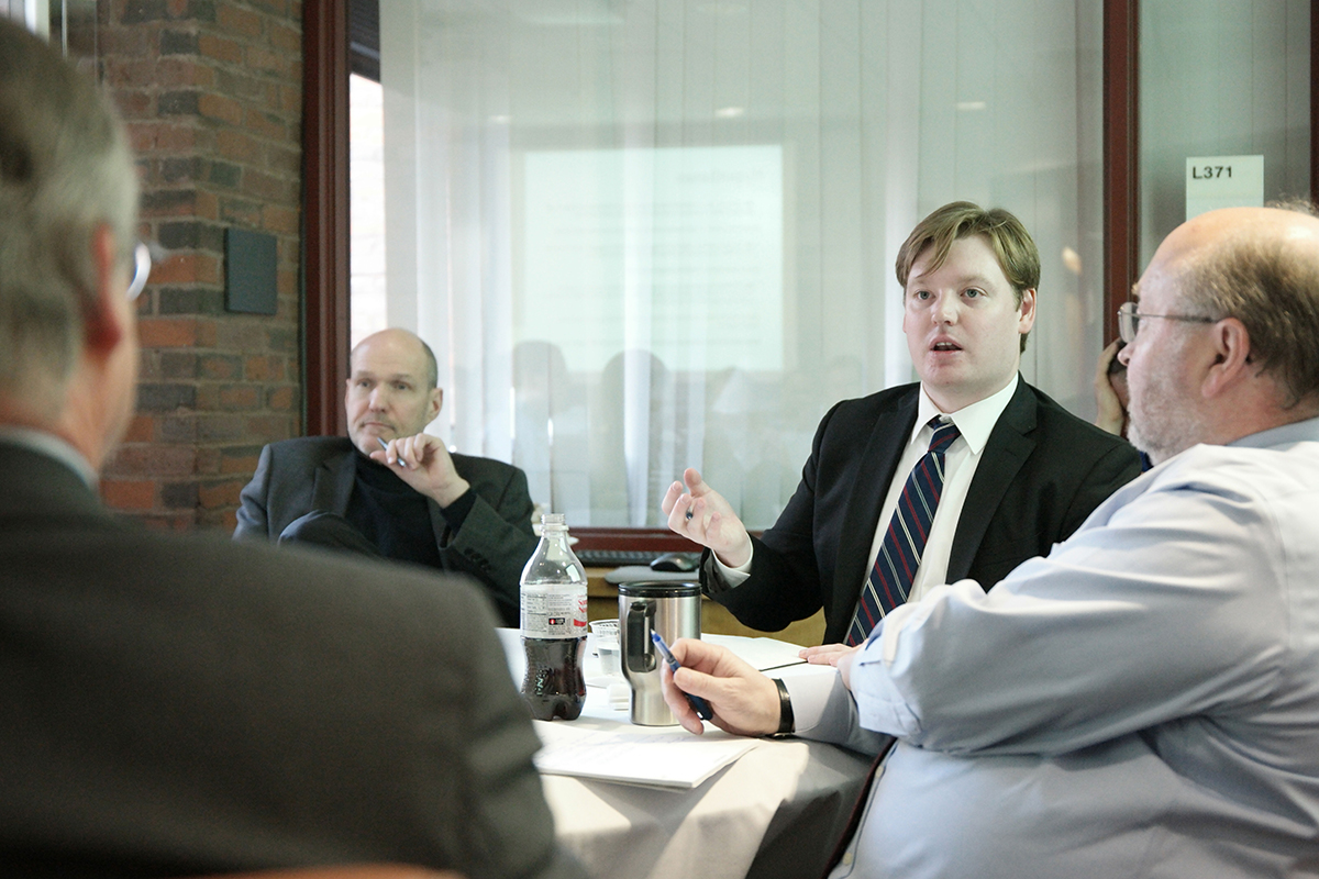 Visiting Assistant Professor of Government Ivan Rasmussen (center) discusses Chinese foreign policy with Stephen Walt (left) and Steven Miller (right).