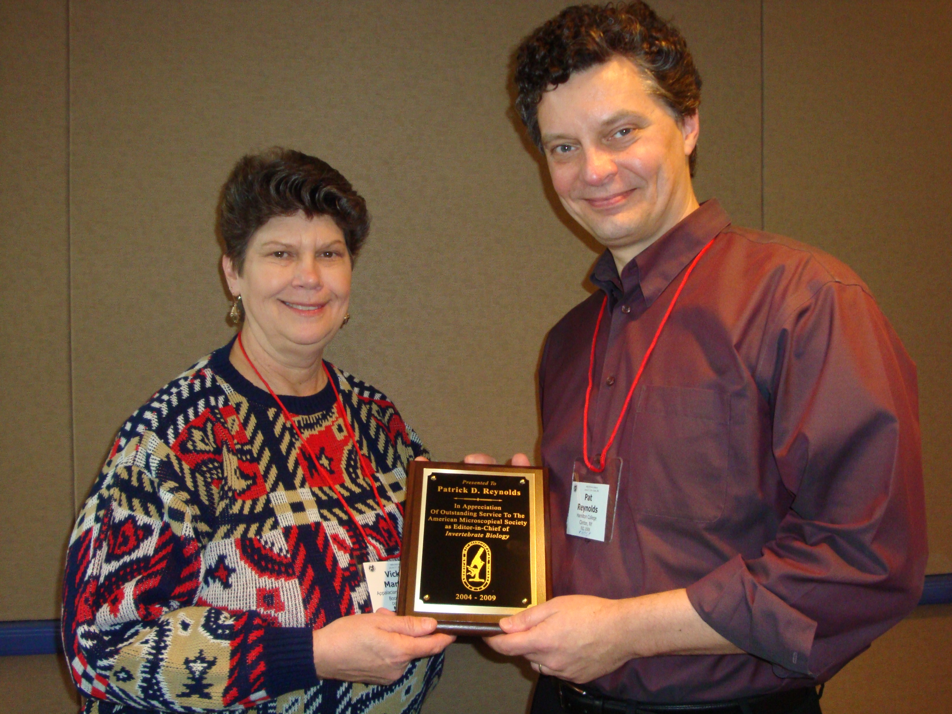 AMS president Vicki Martin presents Pat Reynolds with a plaque at the society's annual meeting.
