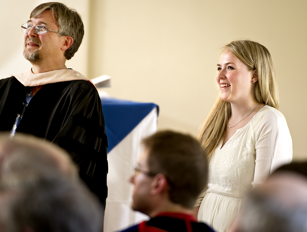 Riley Stepnick '12 with Professor of Music Sam Pellman listens to her song performed by the Choir at Class & Charter Day.