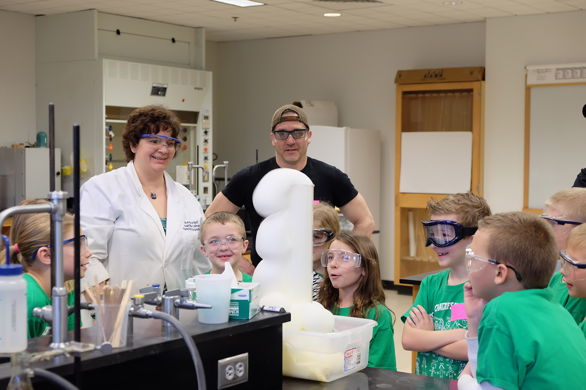 Director of Laboratories Shawna O'Neil prepares elephant's toothpaste in a chemistry lab, with a captive audience.