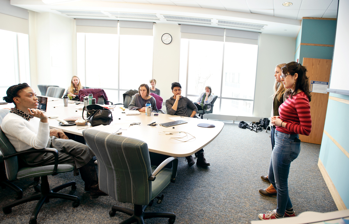 Meghan O'Sullivan '15 and Alicia Rost '15 discuss their non-profit business idea with the group.