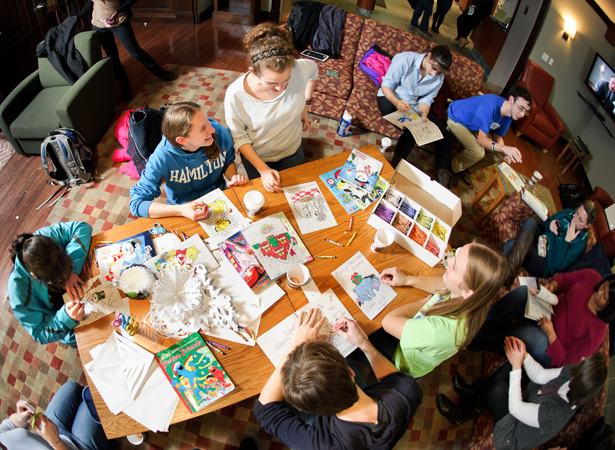 Students color and make paper snow flakes as they participate in a Student Activities big study break in Sadove Center.