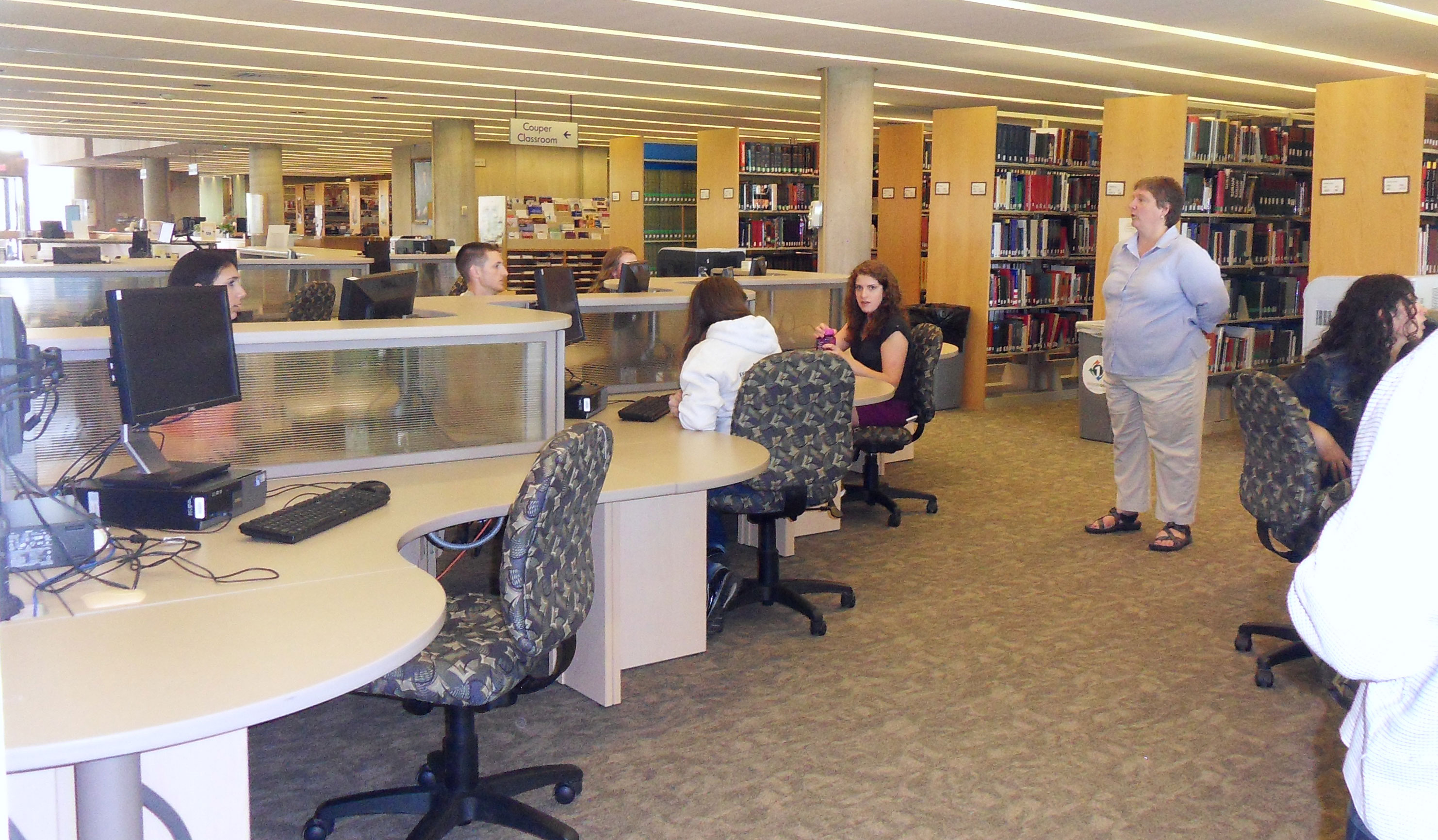Research Librarian Kristin Strohmeyer assists local high school students in Burke Library.