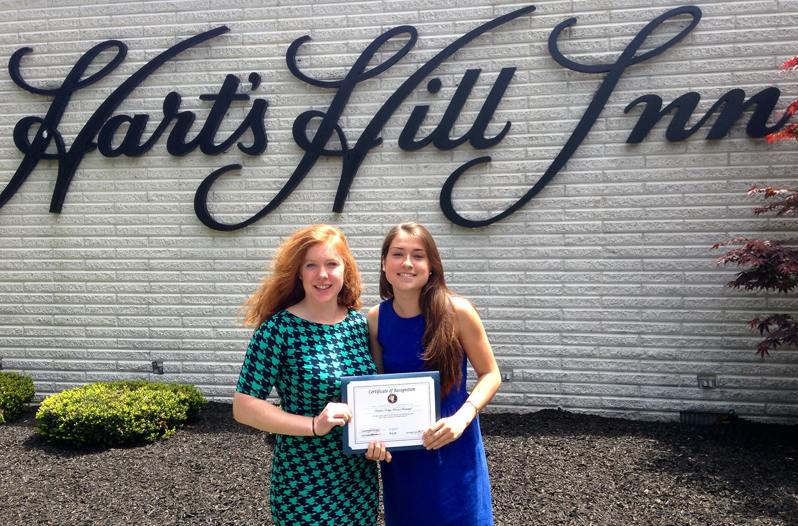 Women's basketball student-athletes Adrianna Pulford '15 and Rachel Fredey '15 with a certificate of recognition from the Oneida County Office for the Aging and Continuing Care as a 2015 Older American Awards Honoree.