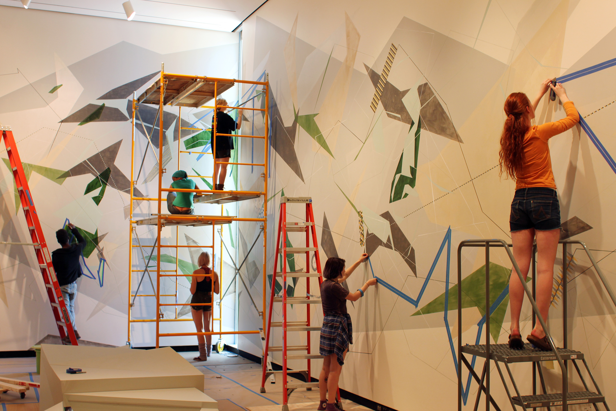 Students help artist Danielle Tegeder complete a 70-foot wall drawing in the Wellin Museum of Art.