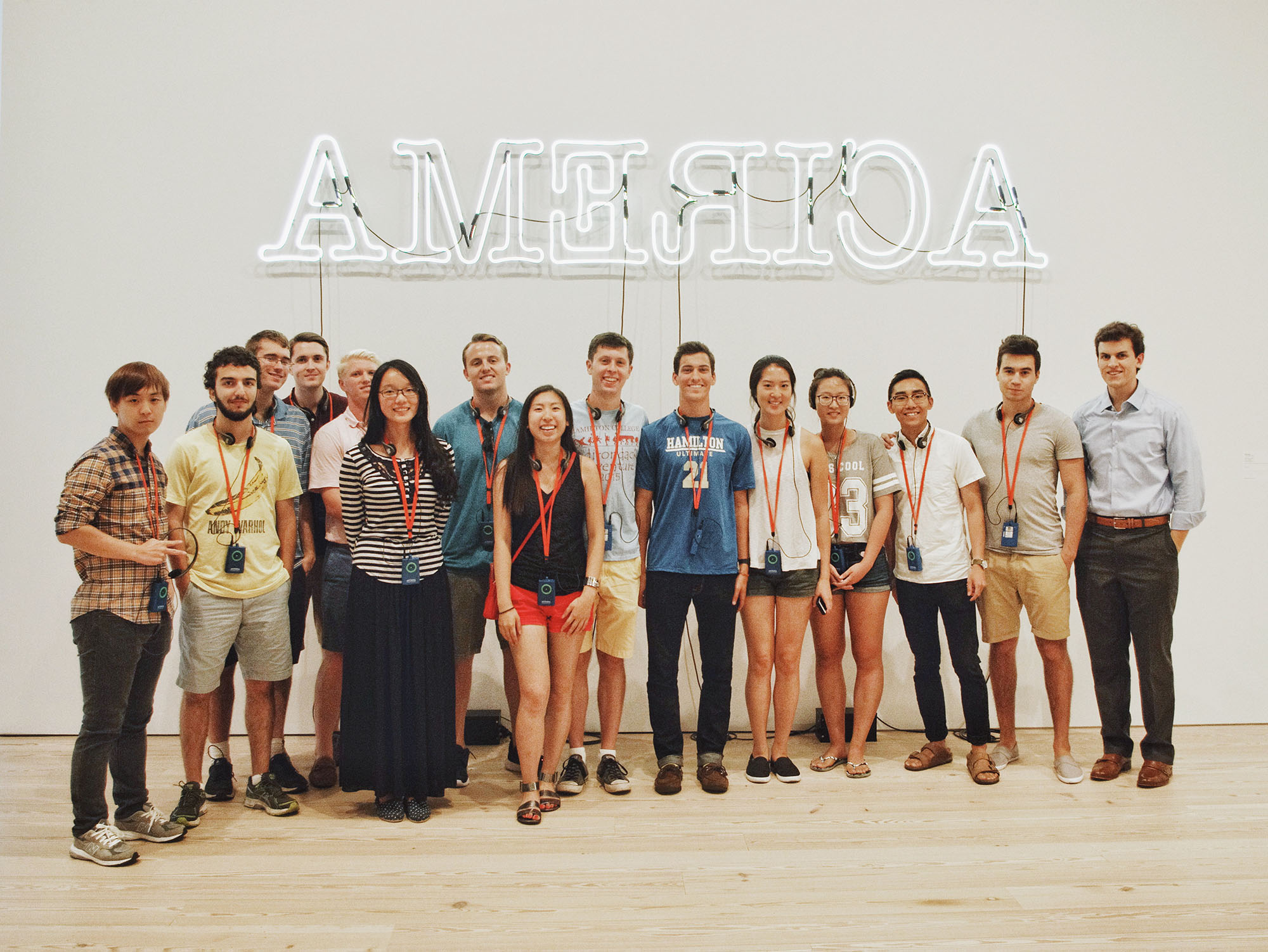 Hamilton NYC Program students in front of Glenn Ligon's neon installation Ruckenfigur. 