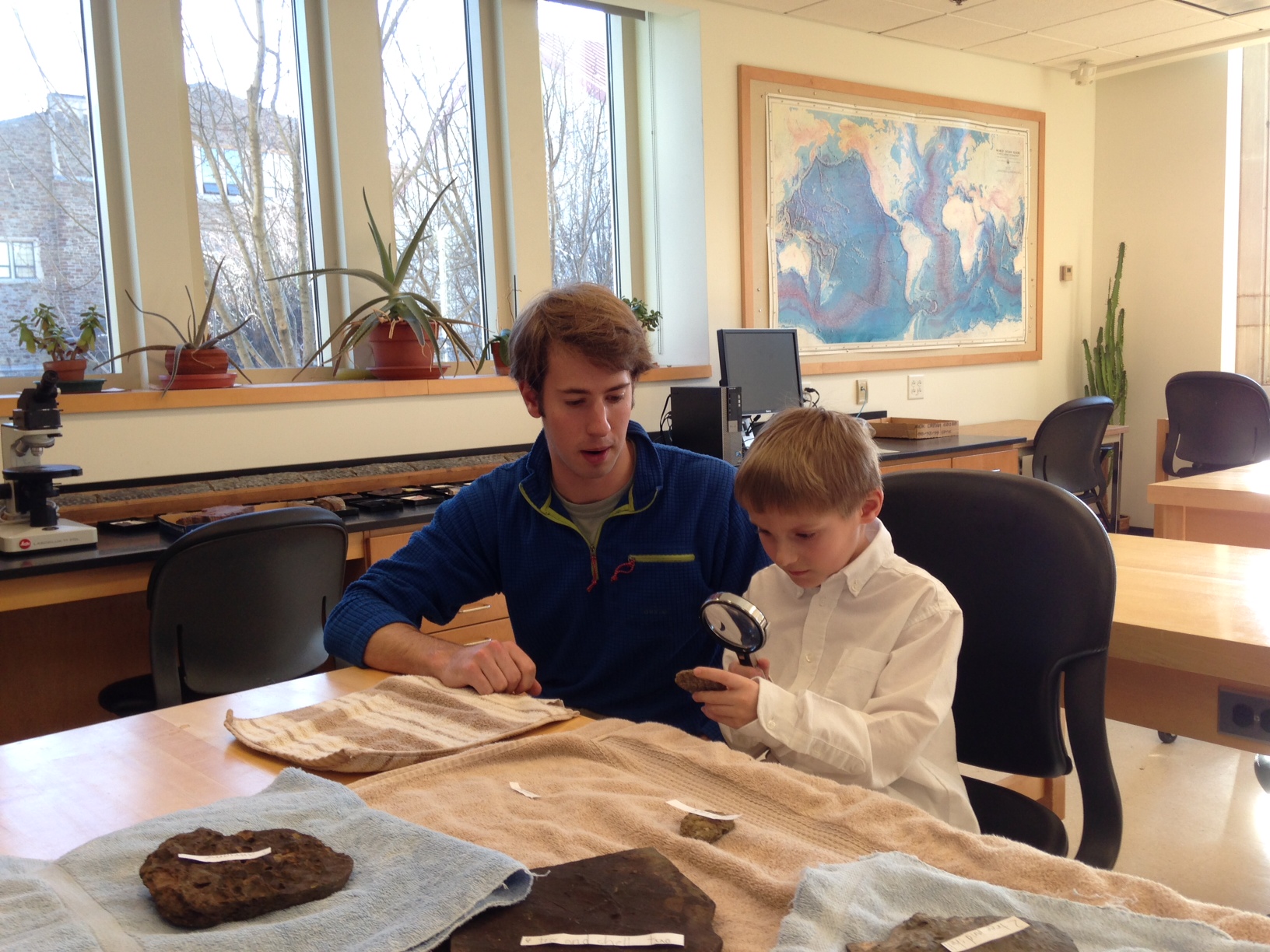 Colyer Woolston '14 and Clinton first grader John Musante examine fossils in the lab.